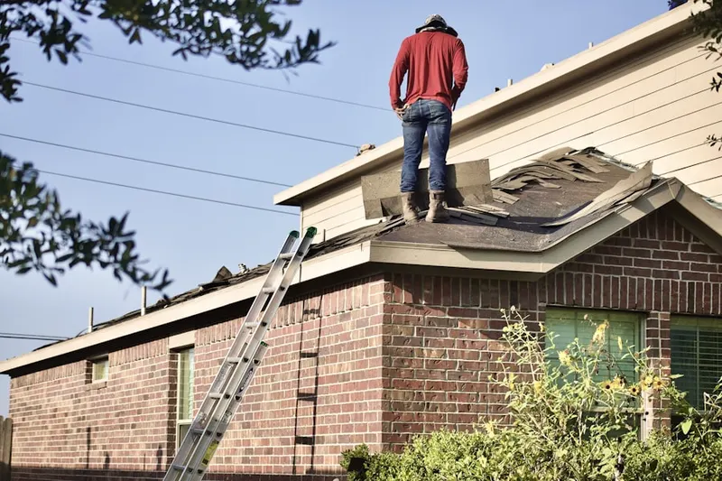 Professional roofer working on a residential roof in Myers Tract